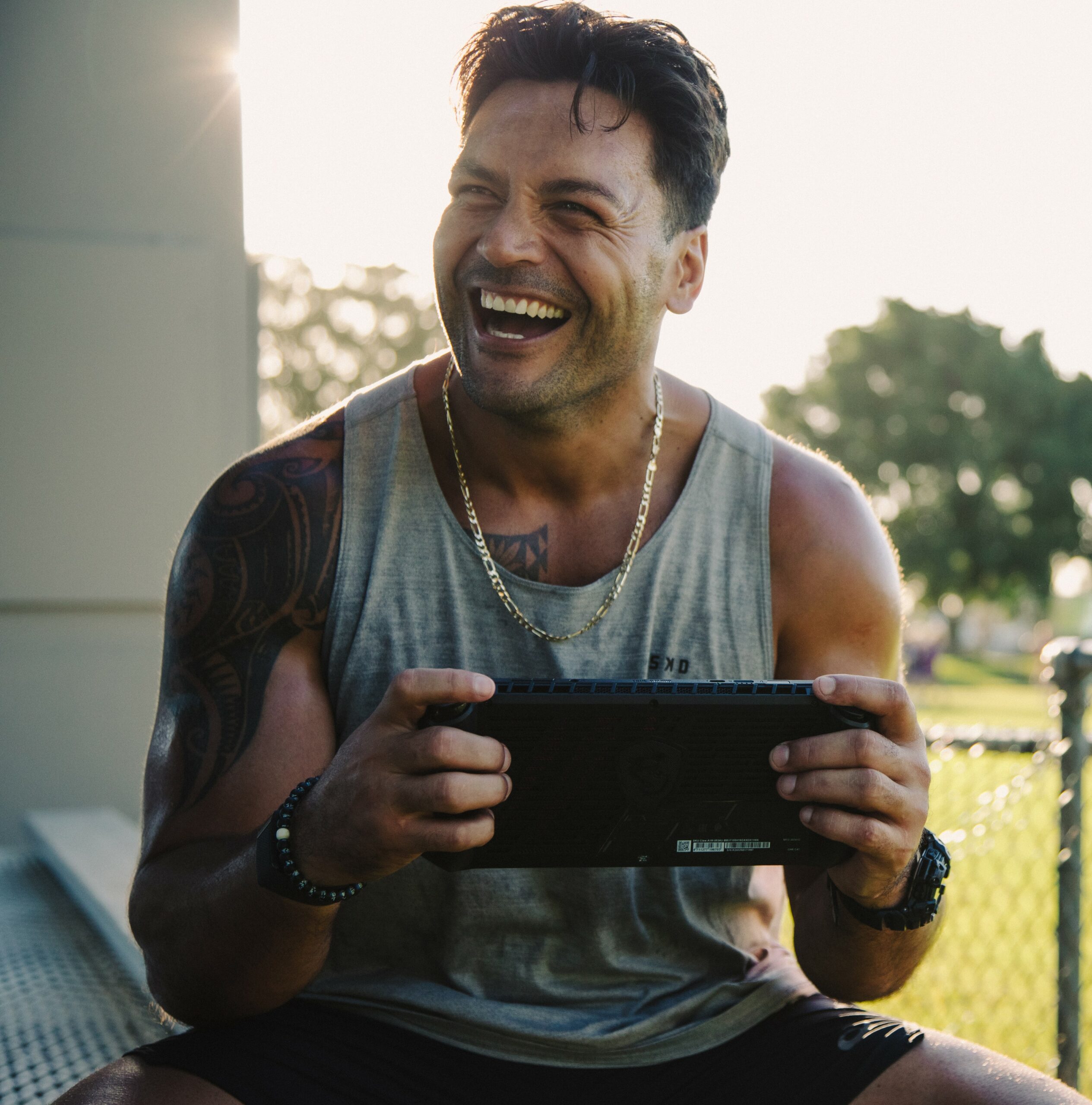 Man holding a handheld gaming console with both hands