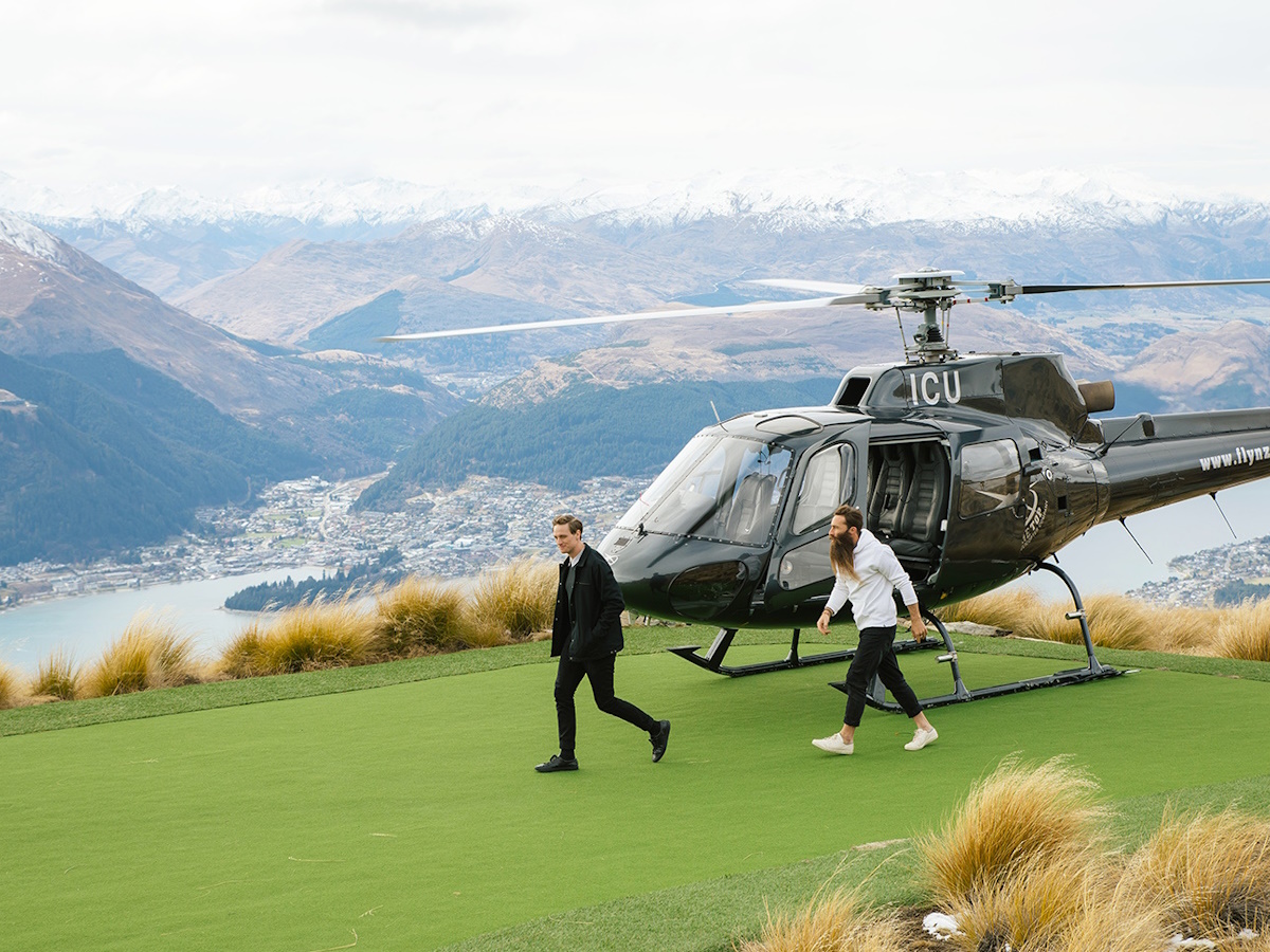 Two men getting off a helicopter