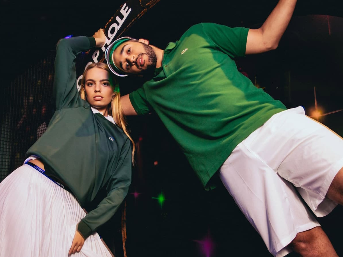 Male and female models in green and white outfits